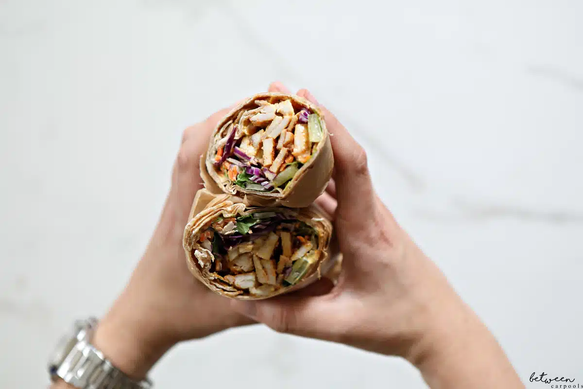 Holding an assembled Chicken Wrap