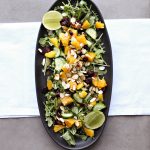 Mango Salad with Silan and Lime Dressing on a black oval platter.