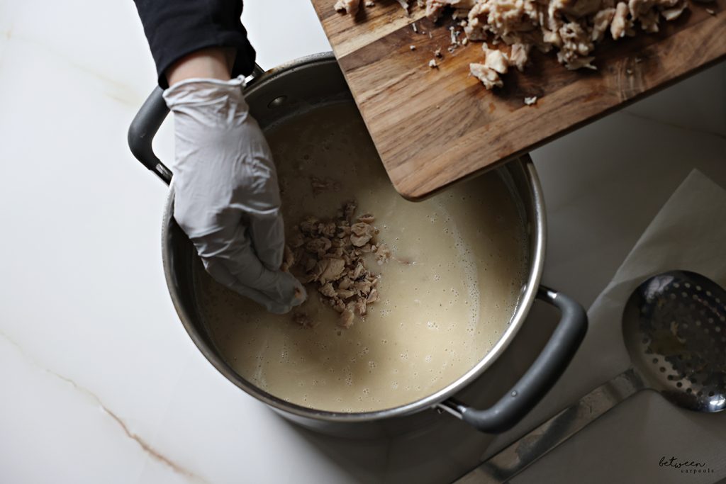 Adding chopped chicken bottoms into blended Cream of Chicken Soup.