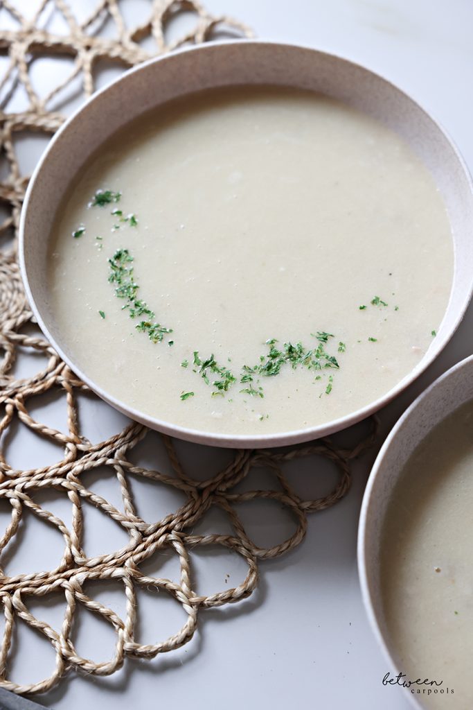 Cream of Chicken Soup, plated with fresh herbs.