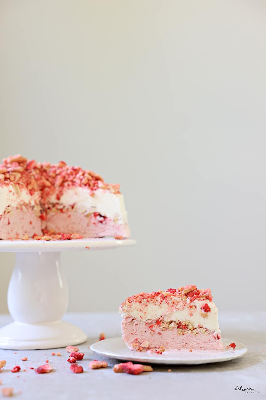 Strawberry Crunch Ice Cream on a cake plate, topped with the rest of the crumbs.