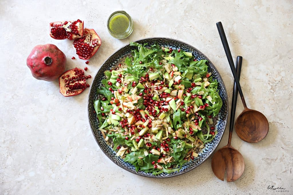 Plated salad, and a small jar of dressing nearby.