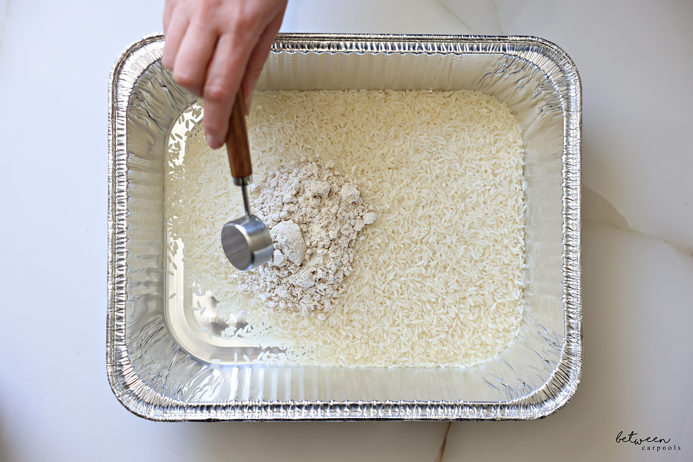 Jasmine rice and onion soup mix in a 9x13 baking pan.