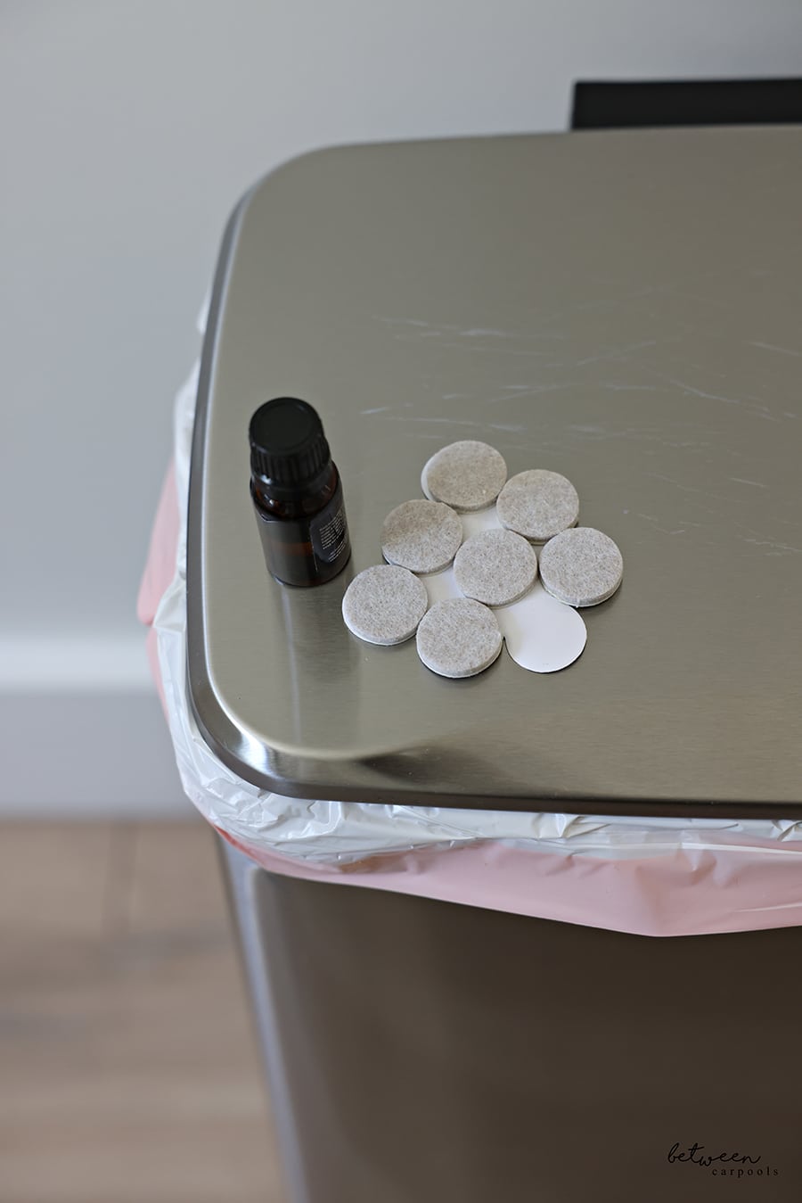 Felt Furniture Pads and a scented oil on the lid of a stainless trash can.