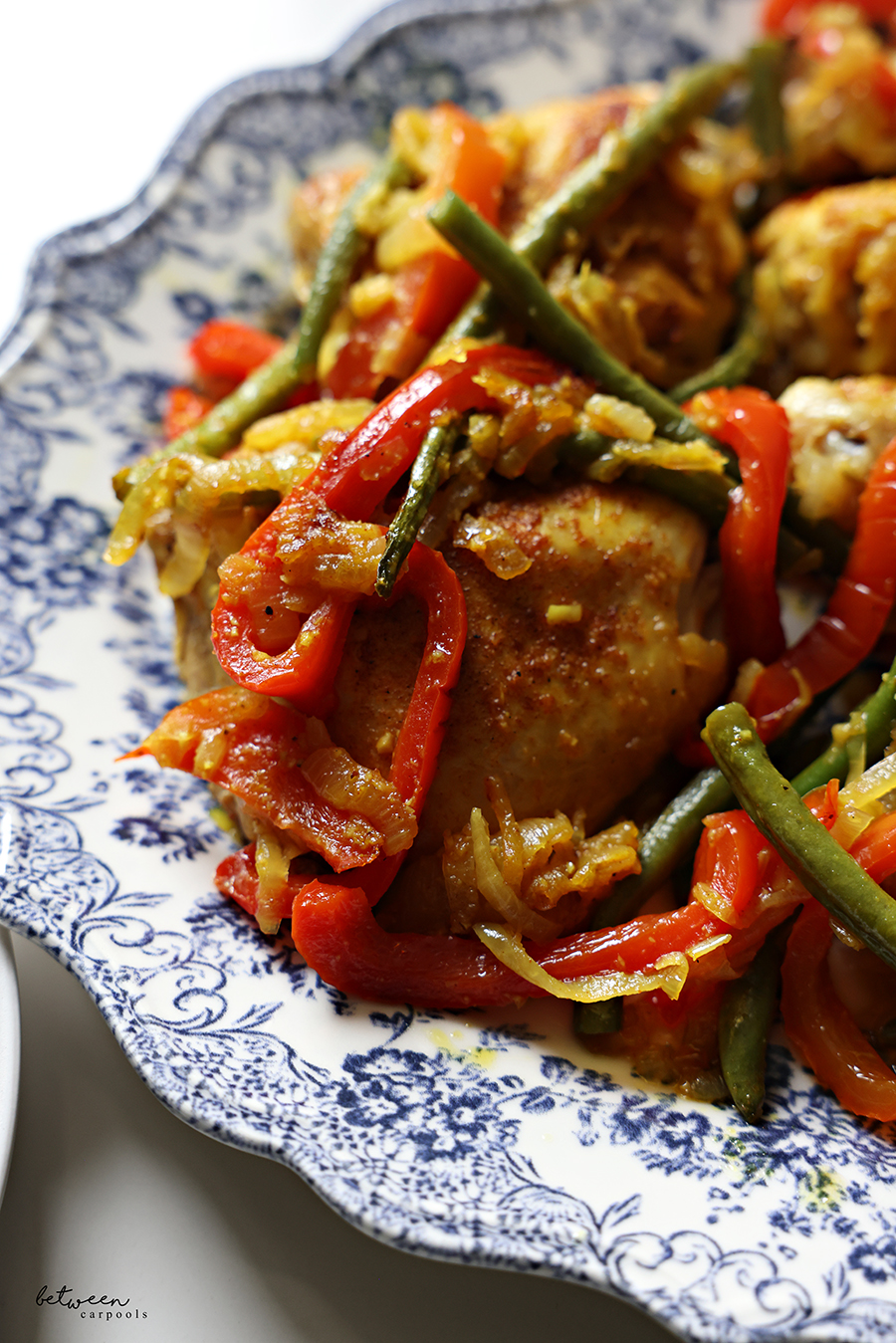 Closeup of Chicken With Green Beans and Roasted Peppers on a platter.