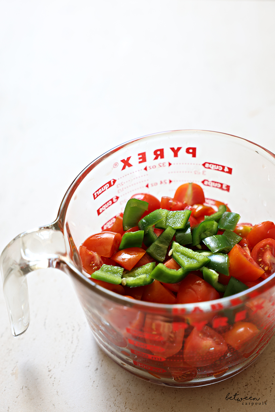 3 cups quartered grape tomatoes and 1 jalapeño, diced, in a Pyrex glass 4 cups measuring cup.