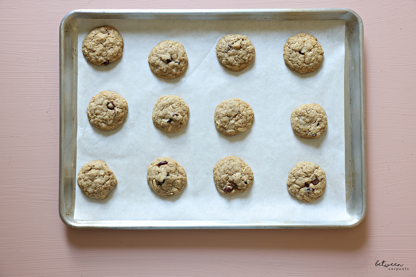 Baked lactation cookies on a parchment lined baking sheet.