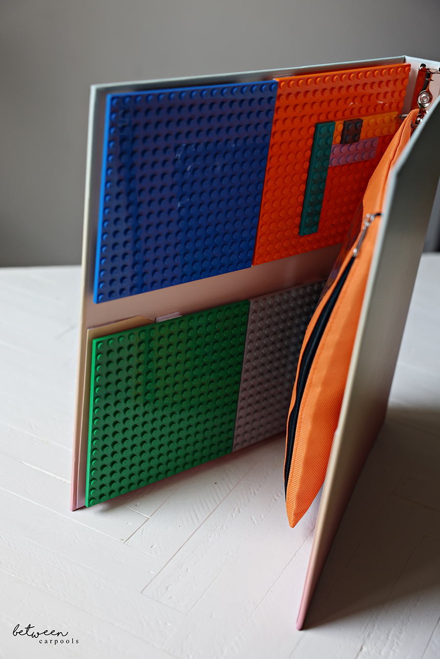 Lego binder with Lego plates, and Lego bricks in a zippered pencil pouch.
