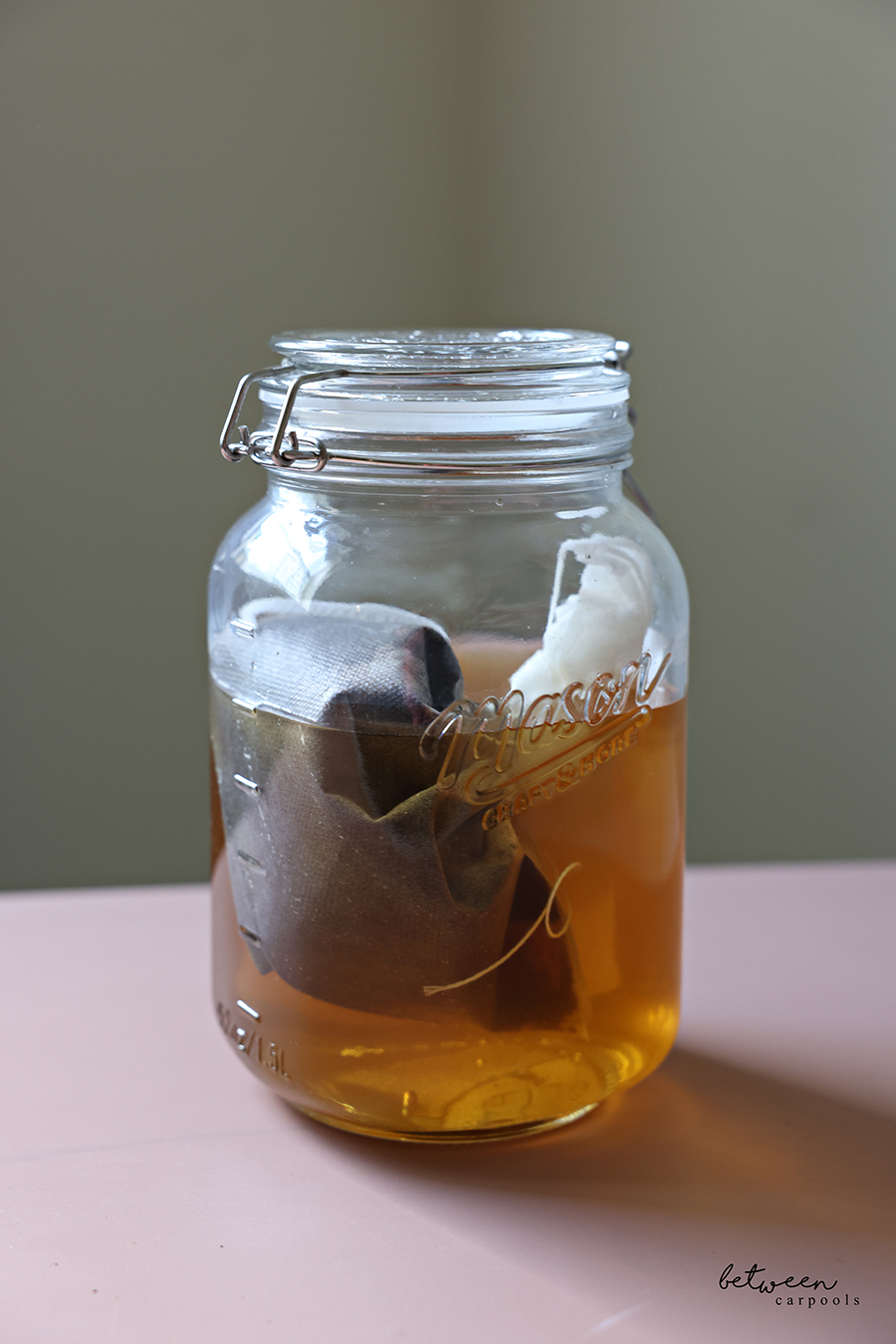Coffee grounds in a cold brew bag in a wide-mouth glass jar with water. Brewing cold brew.