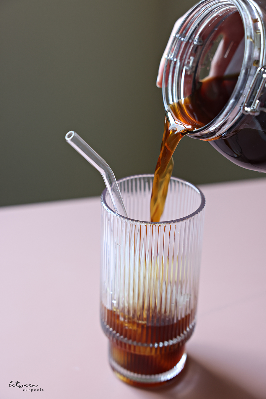 Pouring cold brew over ice.