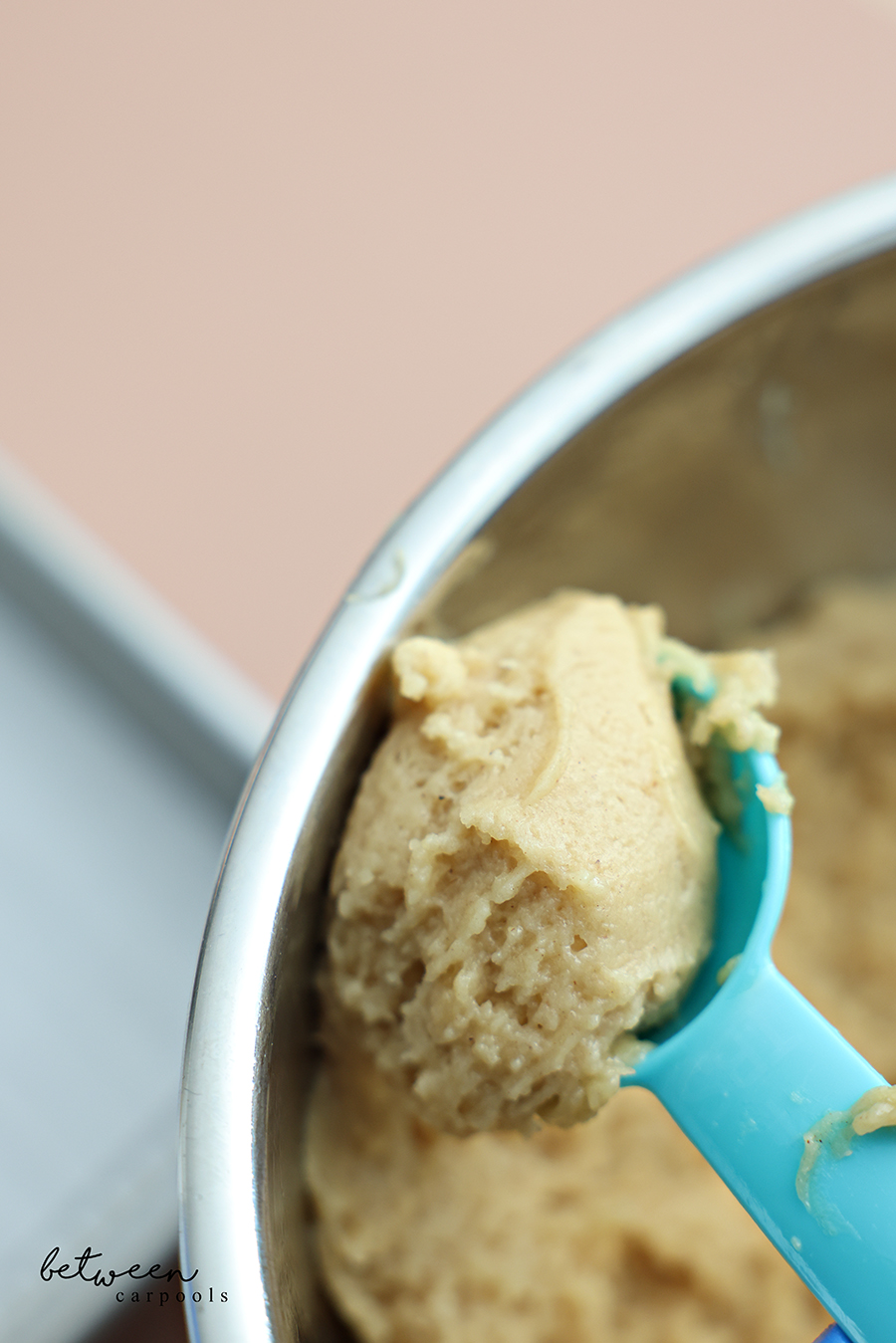 Heaping tablespoon measuring spoon of honey cookie dough.