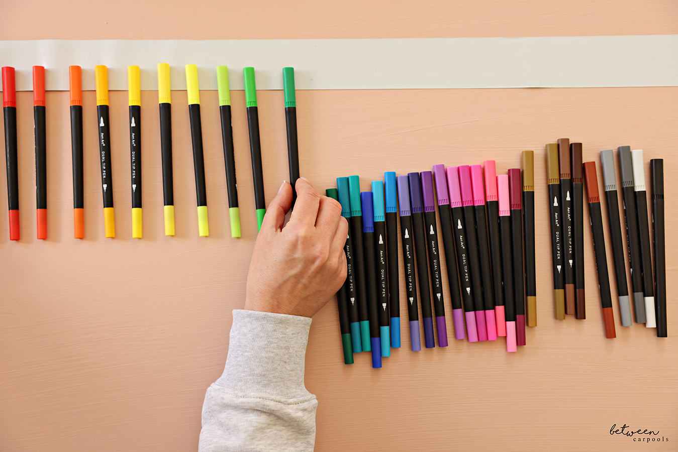 Placing markers on a piece of duct tape, sticky side up.