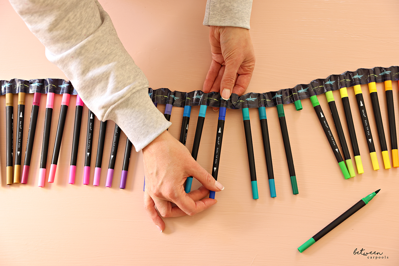 Replacing markers with its caps in a set held together with duct tape.