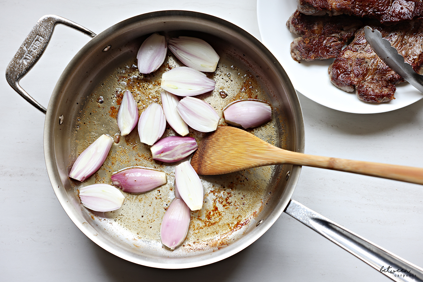 Sautéing halved shallots.