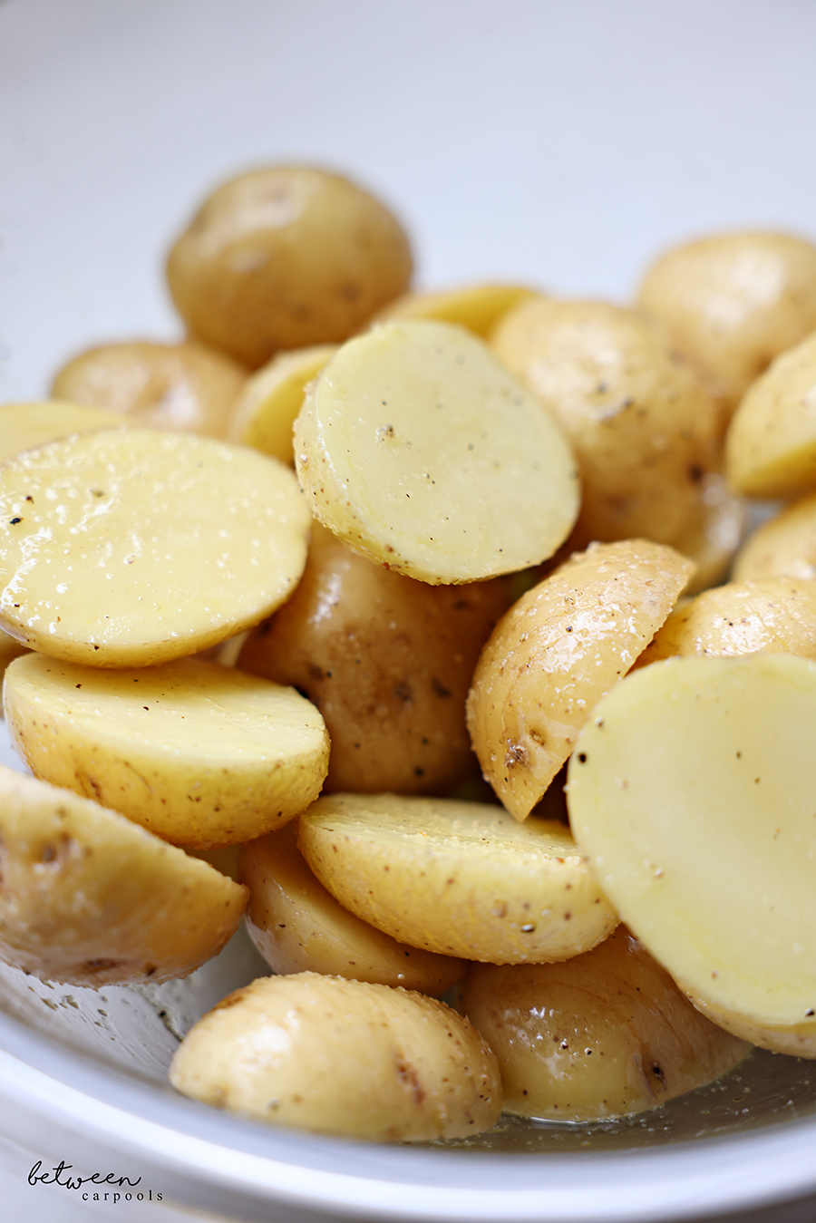Hasselback baby potato halves tossed with olive oil, salt, and pepper.
