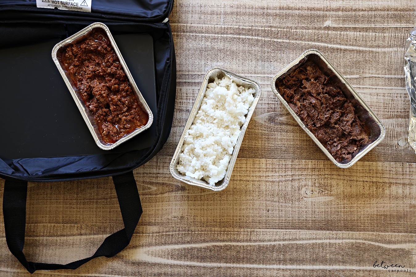 Chili, rice, and shredded beef, in disposable loaf pans with a HOTLOGIC Max Large Portable Electric Food Heater. Open, Top View.