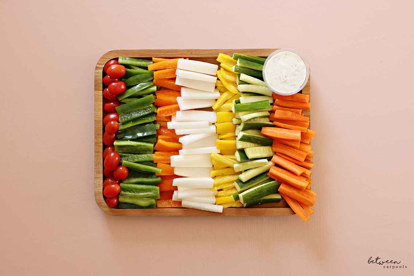 Fresh veggie platter on a bamboo tray.