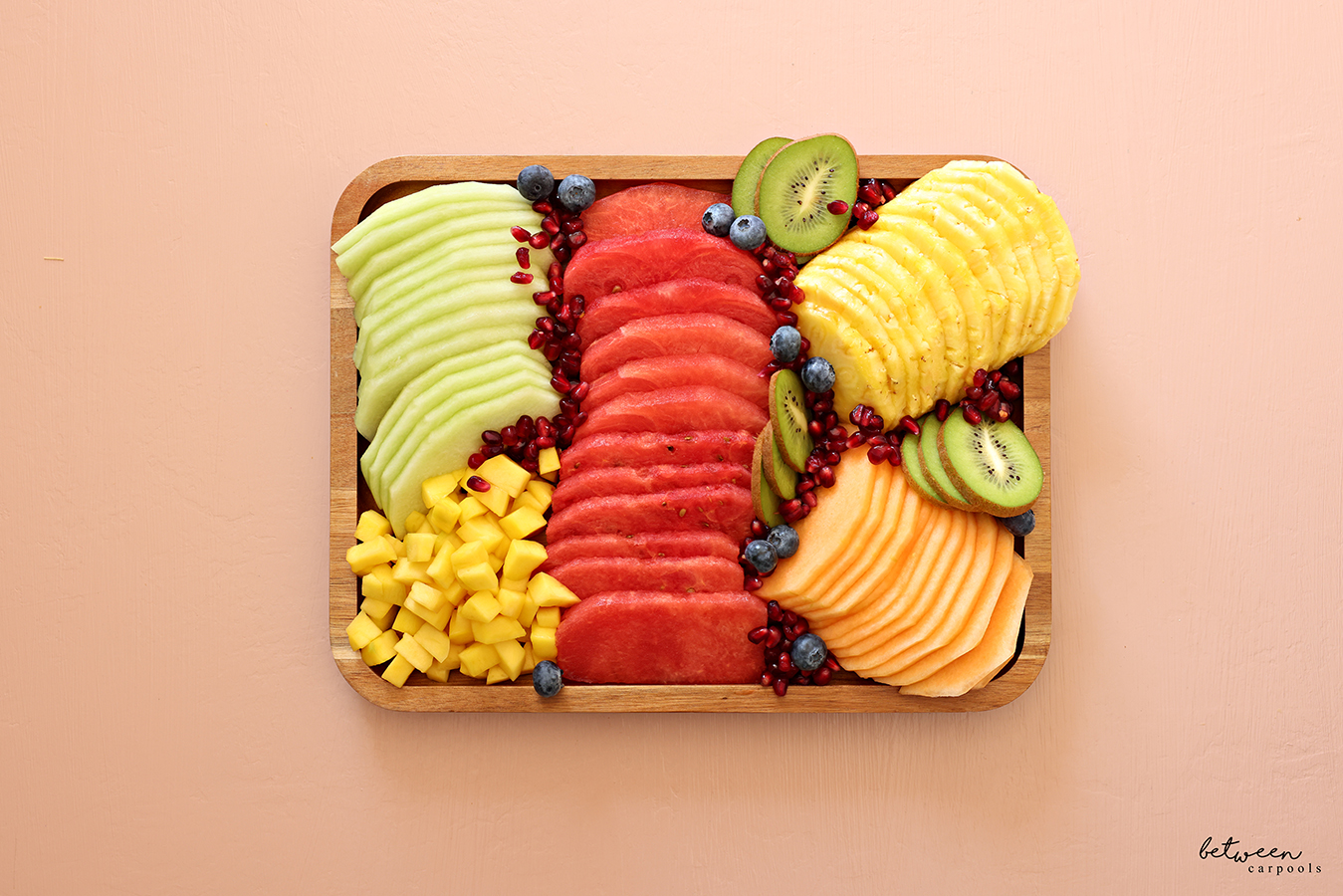 Fresh fruit platter on a bamboo tray.