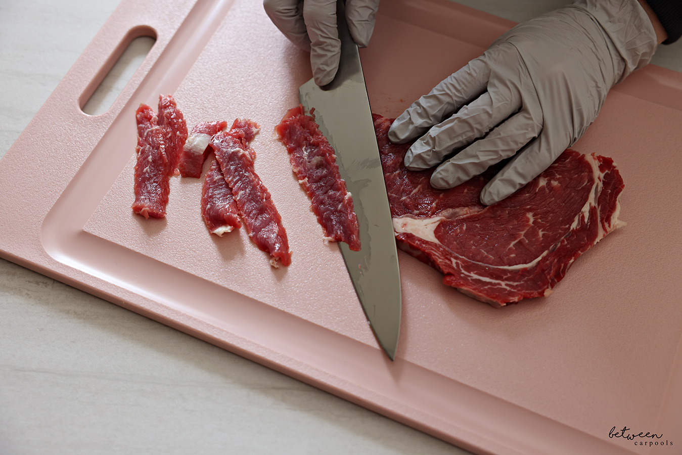Thinly slicing steak.