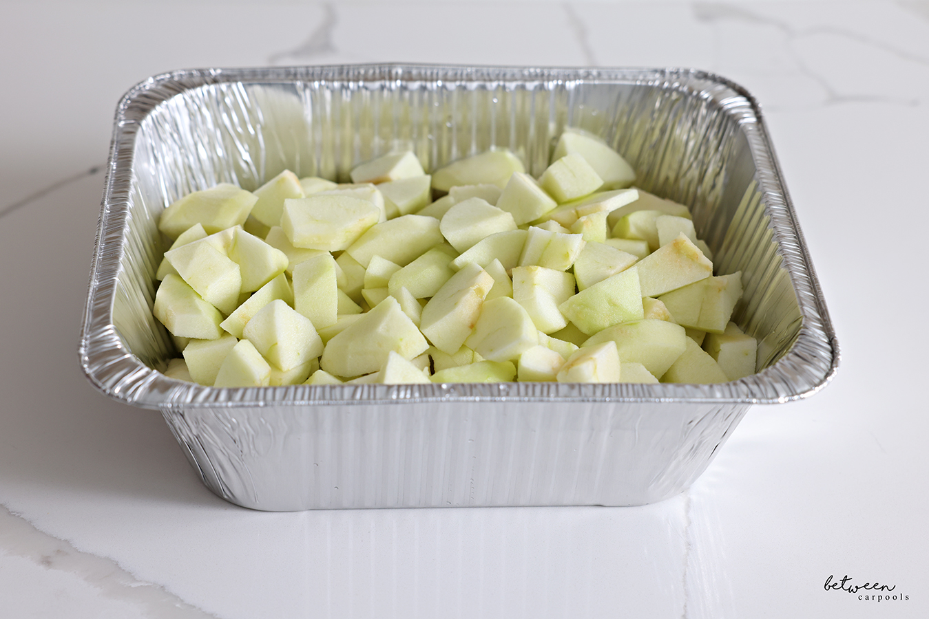 Rinsed chopped apples in a deep 9x13 pan.