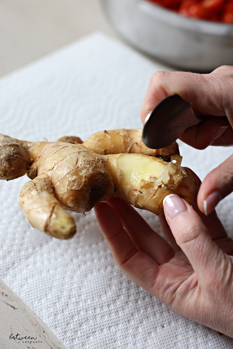 Peeling ginger with a spoon.