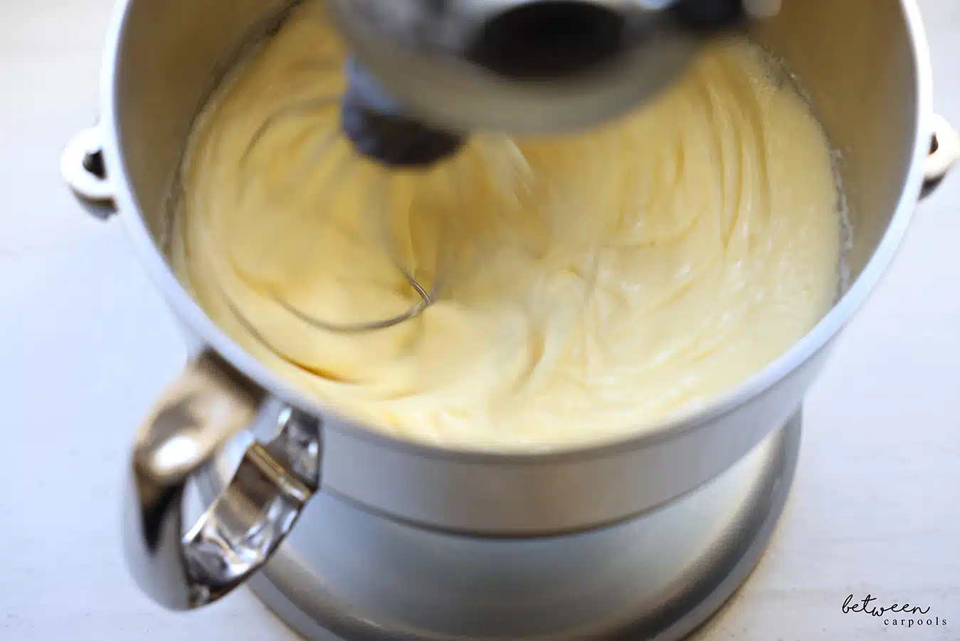 Beating eggs in the bowl of a KitchenAid mixer.