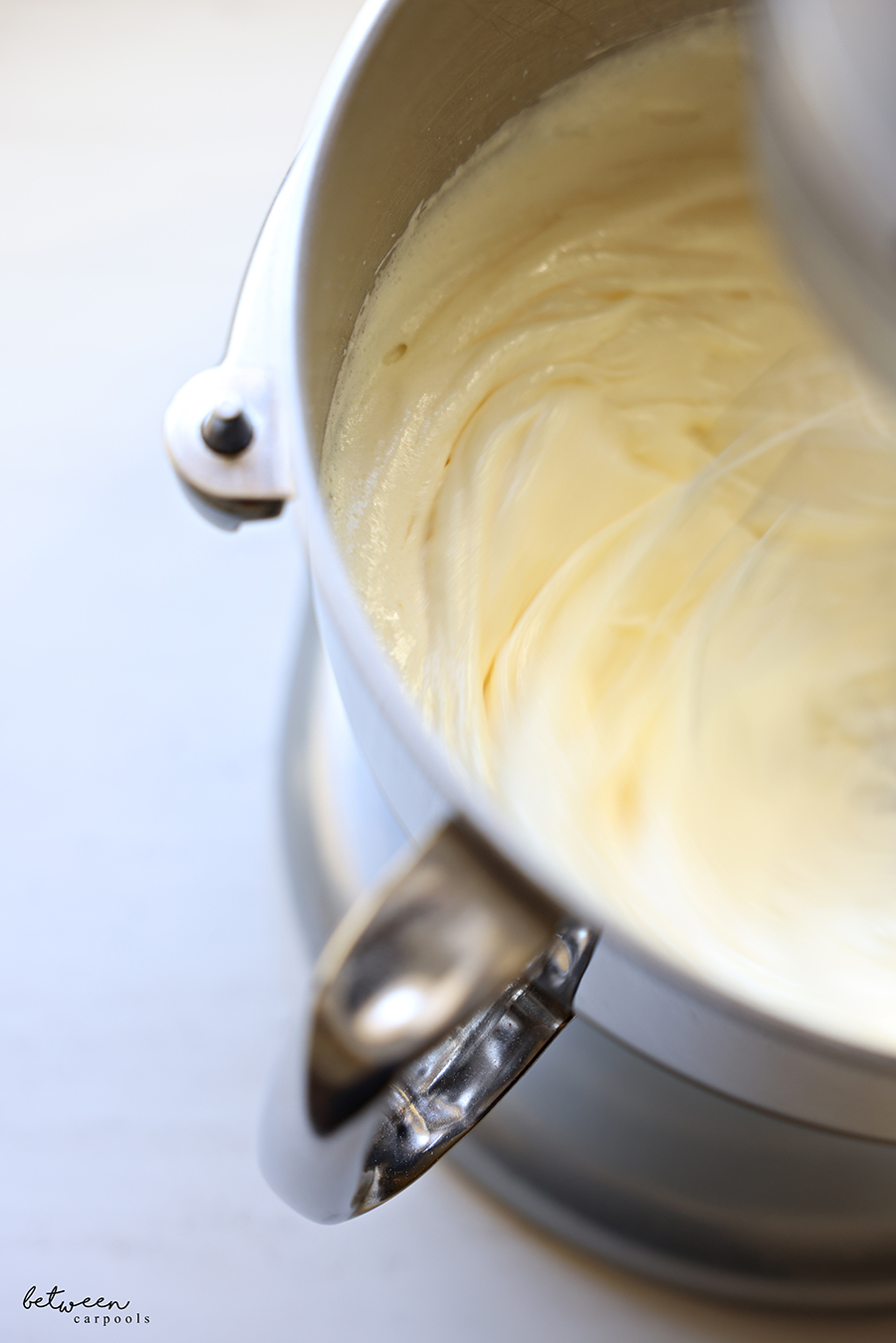 Beating marble cake batter in the bowl of a KitchenAid mixer.